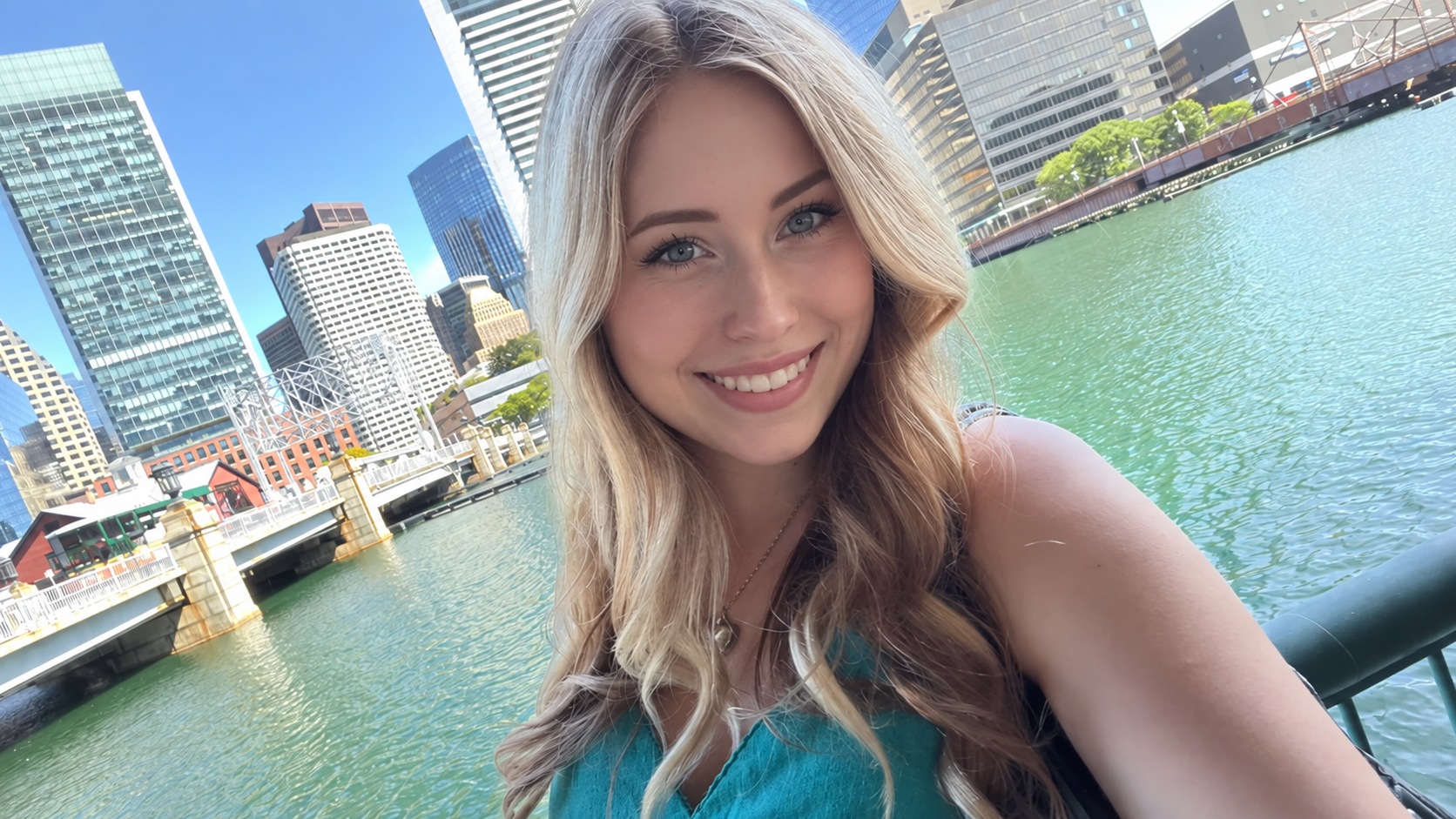 Megan in a turquoise top beside the waterfront